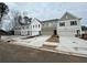 A row of newly constructed townhouses with modern exteriors, two-car garages, and private driveways at 409 Carrera Ln, Acworth, GA 30102