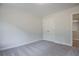 Bedroom features gray carpet, neutral walls, and a closet with a double-door entry at 420 Carrera Ln, Acworth, GA 30102