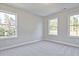 Bright bedroom with three windows and plush gray carpeting at 420 Carrera Ln, Acworth, GA 30102