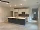 Open-concept kitchen with large island, white cabinets, stylish gray backsplash, and modern finishes at 420 Carrera Ln, Acworth, GA 30102