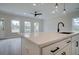 A kitchen island featuring quartz countertops, a black faucet, and seating at 420 Carrera Ln, Acworth, GA 30102