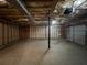 Unfinished basement featuring concrete floors, exposed ceiling, and a garage door for easy access at 47 Brushy Mountain Way, Rockmart, GA 30153