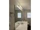 Bathroom featuring a white vanity with a sink, a mirror, a window, and neutral walls at 47 Brushy Mountain Way, Rockmart, GA 30153