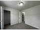 A bright bedroom with neutral walls, carpeted floors, closet, and a view of the hallway at 47 Brushy Mountain Way, Rockmart, GA 30153