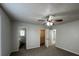 Spacious bedroom with carpeted floors, neutral walls, a ceiling fan, and access to the bathroom and closet at 47 Brushy Mountain Way, Rockmart, GA 30153