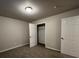 Neutral-toned bedroom with carpet, featuring a closet and two entry doors at 4735 Jackam Ridge Ct, Lithonia, GA 30038