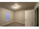 Neutral-toned bedroom with a window bringing in light, providing a relaxing atmosphere at 4735 Jackam Ridge Ct, Lithonia, GA 30038