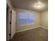 Bedroom with a window featuring light, creating a warm and welcoming space at 4735 Jackam Ridge Ct, Lithonia, GA 30038