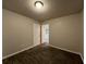 A bedroom boasting wood-look floors, neutral paint, and a view to the ensuite bathroom at 4735 Jackam Ridge Ct, Lithonia, GA 30038