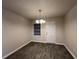 Dining room with modern light fixture, window, and wood-look tile flooring at 4735 Jackam Ridge Ct, Lithonia, GA 30038