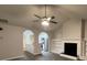 Bright living room featuring a fireplace, vaulted ceiling, modern ceiling fan and hardwood floors at 4735 Jackam Ridge Ct, Lithonia, GA 30038