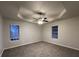 Spacious main bedroom featuring ceiling fan, tray ceiling, and natural light at 4735 Jackam Ridge Ct, Lithonia, GA 30038