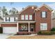 Charming two-story brick home featuring a cozy front porch and attached two-car garage in a well-maintained neighborhood at 2279 Larkspur Run Dr, Duluth, GA 30097