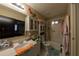 Well-lit bathroom with a shower-tub combo, vanity, and storage cabinets at 5332 Audubon Pl, Norcross, GA 30093