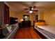 Bedroom with hardwood flooring, ceiling fan, and a large window at 5332 Audubon Pl, Norcross, GA 30093