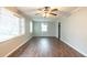 Spacious living room with wood-look floors, ceiling fan, and plenty of natural light at 1440 Kenilworth Sw Dr, Atlanta, GA 30310