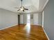 Large main bedroom with hardwood floors, tray ceiling, and view into the ensuite bathroom at 2120 Chartwell Ct, Lawrenceville, GA 30043