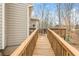 View of the exterior deck highlighting wood railings and a grill and dining area, perfect for outdoor entertaining at 6435 Ivey Creek Cir, Cumming, GA 30040