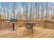 Outdoor deck features a grill and dining area, ideal for enjoying meals in a natural setting at 6435 Ivey Creek Cir, Cumming, GA 30040