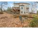 Backyard with a patio, multilevel deck, fire pit, and mature landscaping, offering ideal outdoor living and relaxation spaces at 6435 Ivey Creek Cir, Cumming, GA 30040