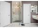Bathroom featuring a tiled glass shower and a vanity with a modern vessel sink at 6435 Ivey Creek Cir, Cumming, GA 30040