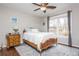 Cozy bedroom features hardwood floors, a ceiling fan, and a window with natural light at 6435 Ivey Creek Cir, Cumming, GA 30040