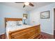 This bright bedroom features a ceiling fan, a window with natural light, and hardwood floors at 6435 Ivey Creek Cir, Cumming, GA 30040