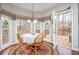 Bright breakfast nook with forest view from large windows and access to outdoor deck at 6435 Ivey Creek Cir, Cumming, GA 30040