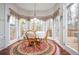 Bright breakfast nook features hardwood floors, wainscoting, and a wall of windows at 6435 Ivey Creek Cir, Cumming, GA 30040