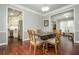 Open dining area with hardwood floors connecting kitchen and living spaces at 6435 Ivey Creek Cir, Cumming, GA 30040
