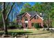 Charming brick home with well-manicured lawn, black shutters, and mature trees at 6435 Ivey Creek Cir, Cumming, GA 30040