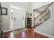 Inviting foyer featuring hardwood floors, staircase, and natural light at 6435 Ivey Creek Cir, Cumming, GA 30040