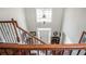 Bright foyer from the staircase, featuring hardwood floors, a transom window, and a chandelier at 6435 Ivey Creek Cir, Cumming, GA 30040