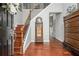 Elegant foyer with hardwood floors, staircase, and wooden accents at 6435 Ivey Creek Cir, Cumming, GA 30040