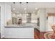 Open kitchen with an island and granite countertops, featuring stainless appliances and white cabinets at 6435 Ivey Creek Cir, Cumming, GA 30040