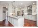 Bright, modern kitchen with white cabinetry, marble countertops, and stainless steel appliances at 6435 Ivey Creek Cir, Cumming, GA 30040