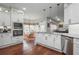 Bright kitchen features white cabinets, stainless appliances, and a view to the breakfast nook at 6435 Ivey Creek Cir, Cumming, GA 30040