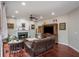 Inviting living room with a fireplace, hardwood floors, and recessed lighting for a warm ambiance at 6435 Ivey Creek Cir, Cumming, GA 30040