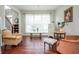 Bright living room featuring hardwood floors, large windows, and decorative furniture at 6435 Ivey Creek Cir, Cumming, GA 30040