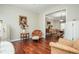 Cozy sitting area with hardwood floors and vintage decor, open to the dining area at 6435 Ivey Creek Cir, Cumming, GA 30040