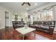 Spacious living room featuring hardwood floors and an open view to the kitchen at 6435 Ivey Creek Cir, Cumming, GA 30040