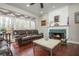 Bright living room with a marble fireplace, hardwood floors, and large windows overlooking the deck at 6435 Ivey Creek Cir, Cumming, GA 30040