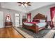 Spacious main bedroom features hardwood floors, an area rug, and ensuite bathroom access at 6435 Ivey Creek Cir, Cumming, GA 30040