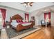 Large bedroom with vaulted ceiling, hardwood floors, a ceiling fan, and abundant natural light at 6435 Ivey Creek Cir, Cumming, GA 30040