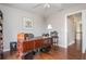 Spacious home office with hardwood floors, large desk, and plenty of natural light at 6435 Ivey Creek Cir, Cumming, GA 30040