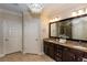 Bathroom showcasing double sinks, granite countertops, and dark wood cabinetry at 950 Brook Knoll Ln, Cumming, GA 30041