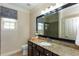 A single sink bathroom with a granite countertop and a dark wood cabinet at 950 Brook Knoll Ln, Cumming, GA 30041