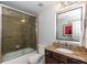 Updated bathroom featuring a glass shower door and granite countertop at 950 Brook Knoll Ln, Cumming, GA 30041
