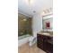 Bathroom with granite counters, tile floors, and a shower over tub at 950 Brook Knoll Ln, Cumming, GA 30041