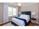 Cozy bedroom with a large window, hardwood floors, and neutral decor at 950 Brook Knoll Ln, Cumming, GA 30041
